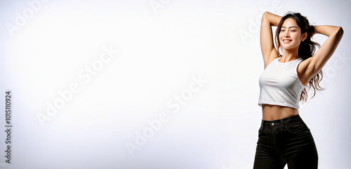 A portrait of an Asian woman stretching with her arms behind her back.