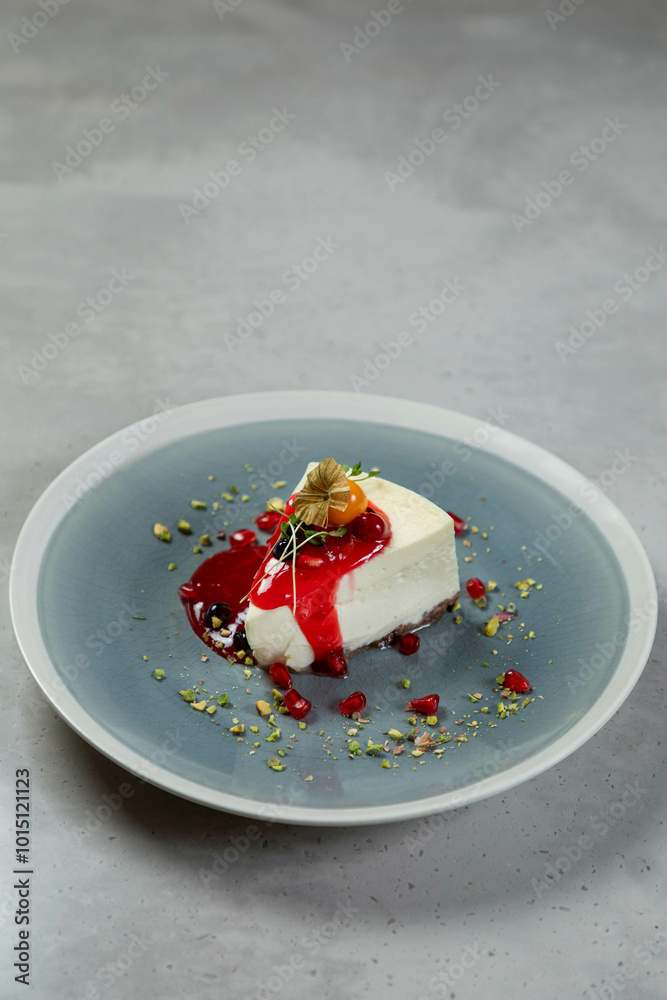 Slice of delicious cheesecake with berry sauce topping served on plate Slice of delicious cheesecake with berry sauce topping served on plate