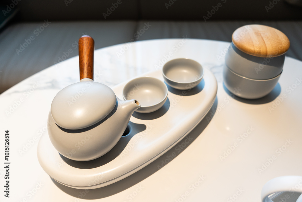 Asian Chinese ceramic tea set in hotel room, warm lighting atmosphere Asian Chinese ceramic tea set in hotel room, warm lighting atmosphere