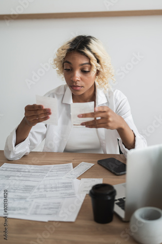 shocked woman looking at the bills to pay. Expenses,credit card statements. Debt,bankruptcy, loan concept photo