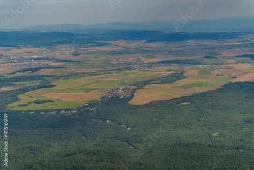 View from the mountain peaks to the distant small towns in the valley