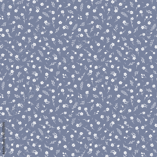 Cute floral pattern in the small flowers. Seamless vector texture. Elegant template for fashion prints. Printing with small white chamomile flowers. Light gray blue background. Stock print.