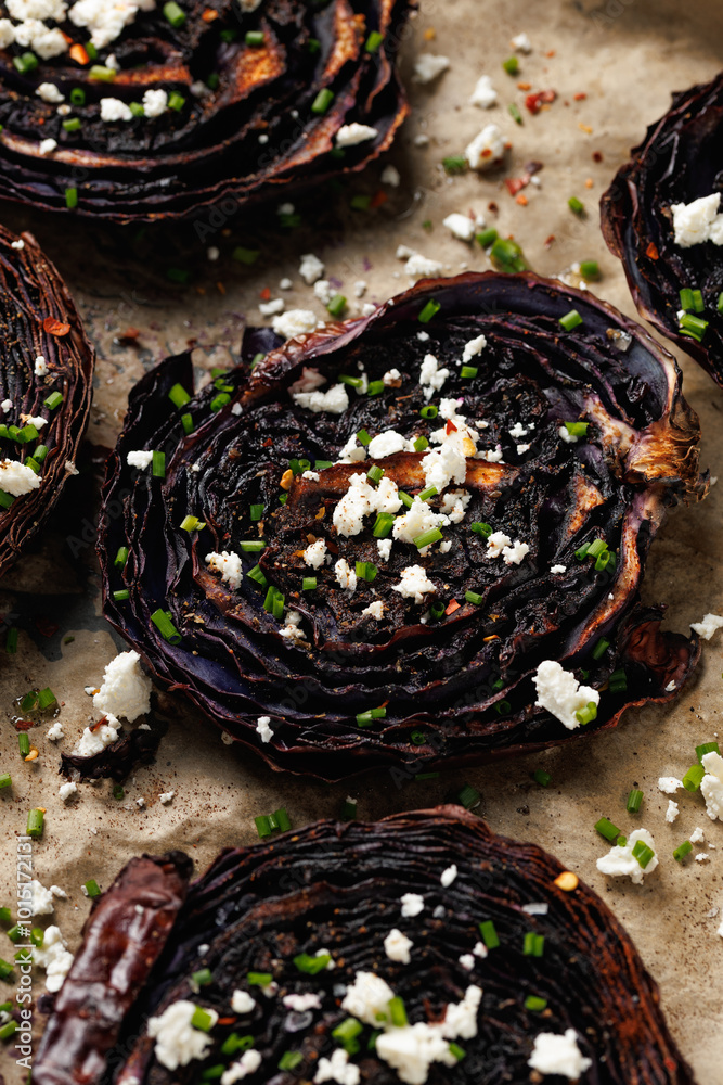 Fototapeta premium Baked red cabbage steaks with herbs and feta cheese