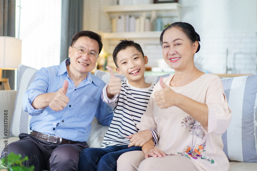 Asian family with father, mother, and son staying in living room together. Asian family with father, mother, and son staying in living room together.