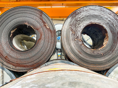 Rolls of rusty steel sheet inside the factory or warehouse. Problem on the surface of metal or iron. 