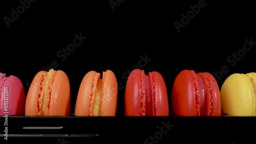 Close-up of macaron cookies from almond dough on the black background.