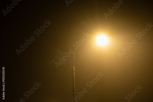 Sodium street lamp on a foggy night