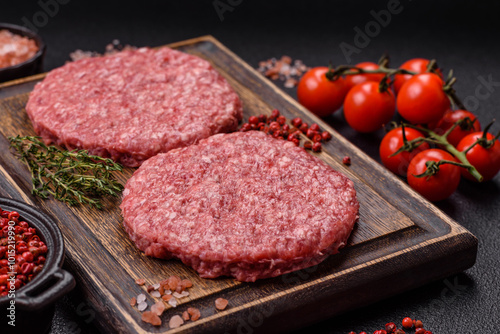 Fresh raw ground beef burger patty with salt and spices