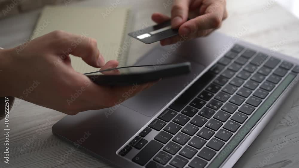 A bank card is in the hands of a man.
A person pays for services with a card.
Online payment for services.
Businessman with a bank card in his hands.
Banking operations.
Online shopping.
Payment