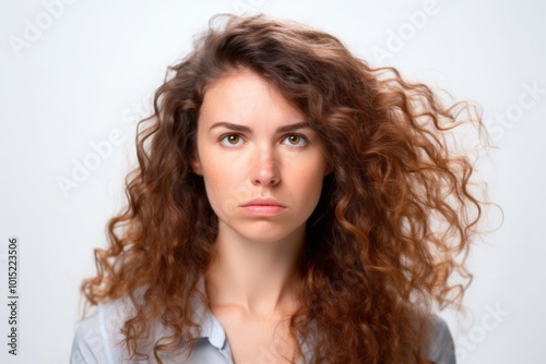 A 35-year-old overweight woman with curly hair looking upset against a neutral background.