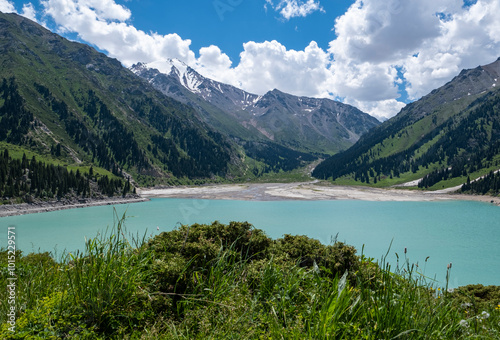 Panorama of Big Almaty Lake in the mountains in summer. Beautiful high-mountain lake not far from Almaty. photo