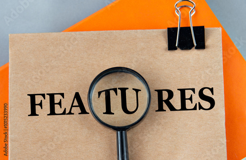 Photography FEATURES - word on a brown sheet with a magnifying glass in the center