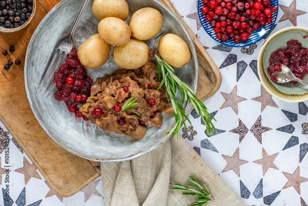 Traditional Norwegian reindeer stew with lingonberries and boiled potatoes Traditional Norwegian reindeer stew with lingonberries and boiled potatoes