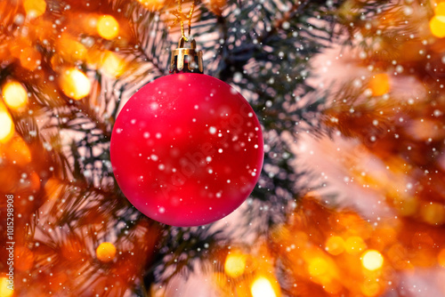 round red Christmas tree toy near a fir tree branch during snowfall