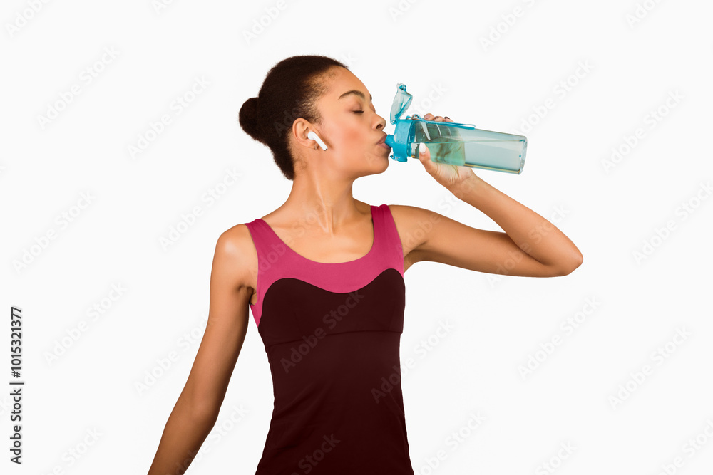 Hydration And Workout. Fit Afro Girl Drinking Water From Bottle Standing Over White Studio Background. Isolated Hydration And Workout. Fit Afro Girl Drinking Water From Bottle Standing Over White Studio Background. Isolated