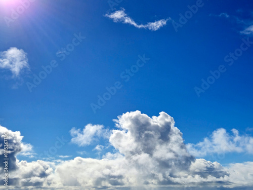 White fluffy clouds in the summer sky and natural landscape background