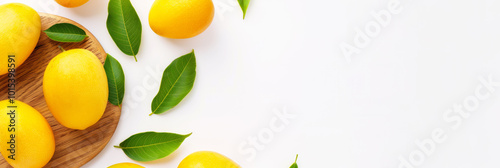 Ripe yellow mango with green leaves on white background, top view