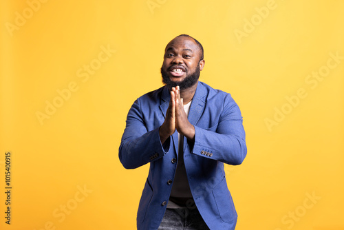 Canvas Print Friendly african american man putting hands together in apology gesture, asking for forgiveness