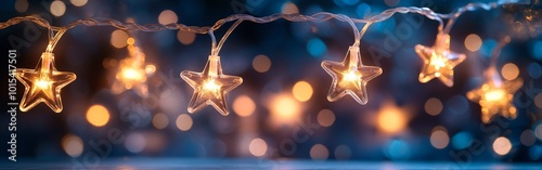 Christmas star string lights glowing with festive bokeh in blue night sky