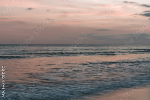 Soft waves rolling in under a pastel-colored sky at dusk, abstract seascape