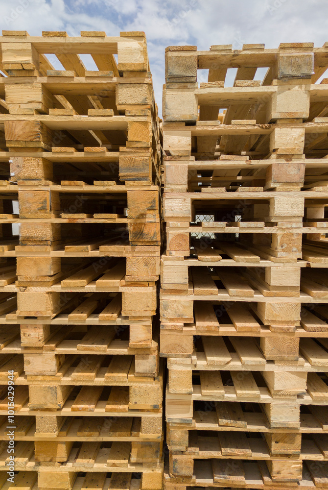 Stacked european stringer pallets. Wooden flat structure which supports goods Stacked european stringer pallets. Wooden flat structure which supports goods