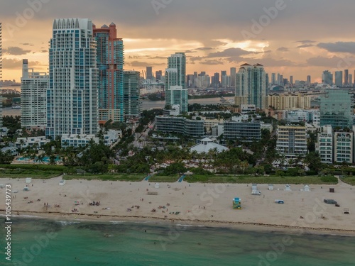 Beach goers in the water and sunbathing on Miami Beach - South Beach, Miami, Florida, United States. photo