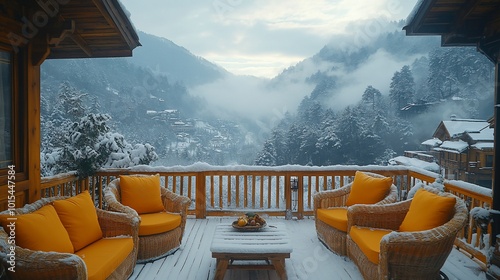 A cozy wooden patio with yellow cushions overlooking a snowy mountain valley. photo