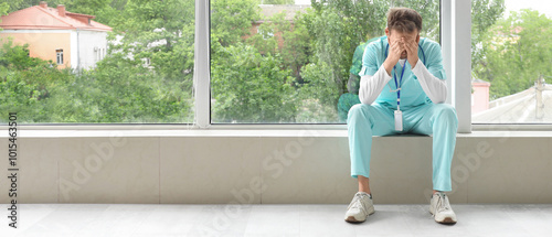 Tired medical intern near w...