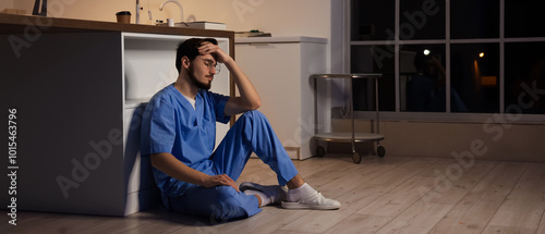 Tired male nurse sitting on...