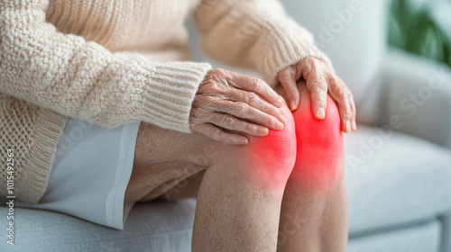 elderly older woman knee joint pain illustration of the bone and red spot of the painful area of the kneecap  photo