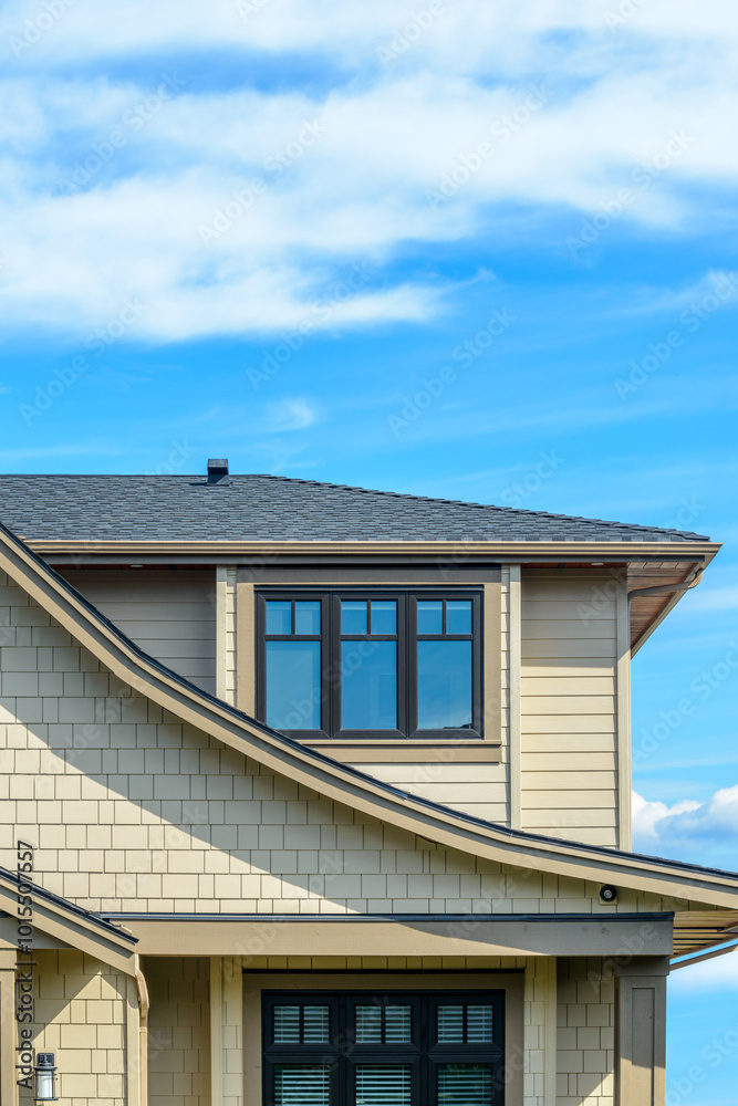 A perfect neighborhood. Houses in suburb at Fall in the north America. Top of a luxury house with nice window over blue sky. A perfect neighborhood. Houses in suburb at Fall in the north America. Top of a luxury house with nice window over blue sky.