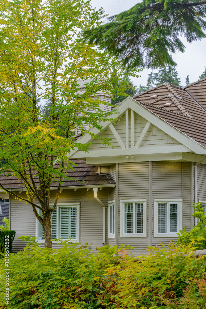 A perfect neighborhood. Houses in suburb at Fall in the north America. Top of a luxury house with nice window over blue sky. A perfect neighborhood. Houses in suburb at Fall in the north America. Top of a luxury house with nice window over blue sky.