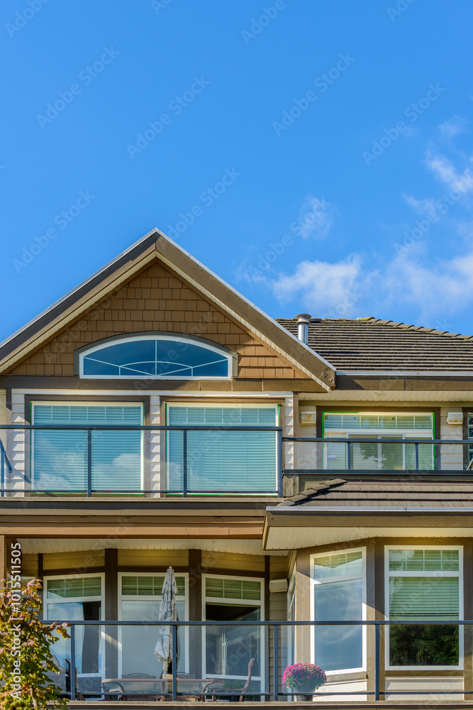 A perfect neighborhood. Houses in suburb at Fall in the north America. Top of a luxury house with nice window over blue sky. A perfect neighborhood. Houses in suburb at Fall in the north America. Top of a luxury house with nice window over blue sky.