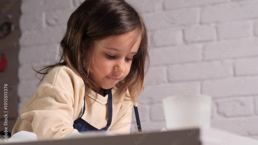 a little girl enthusiastically draws with a pencil a little girl enthusiastically draws with a pencil