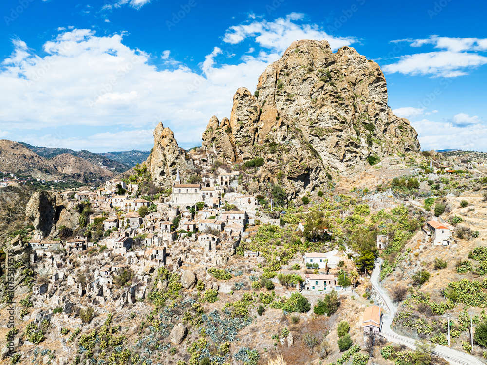 Naklejka premium Mountains and Olive groves around Ghost Town from a drone, Pentedattilo Village, Calabria, Italy, Europe