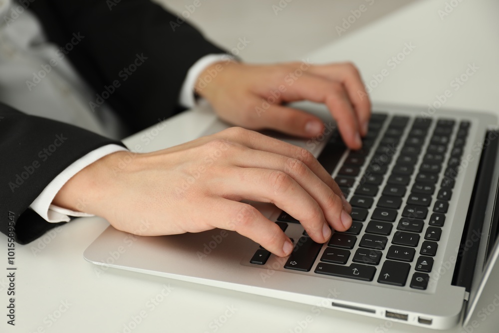 Businesswoman using laptop at white table indoors, closeup. Modern technology Businesswoman using laptop at white table indoors, closeup. Modern technology