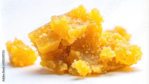 Golden cannabis resin crumble wax on asymmetric pieces
