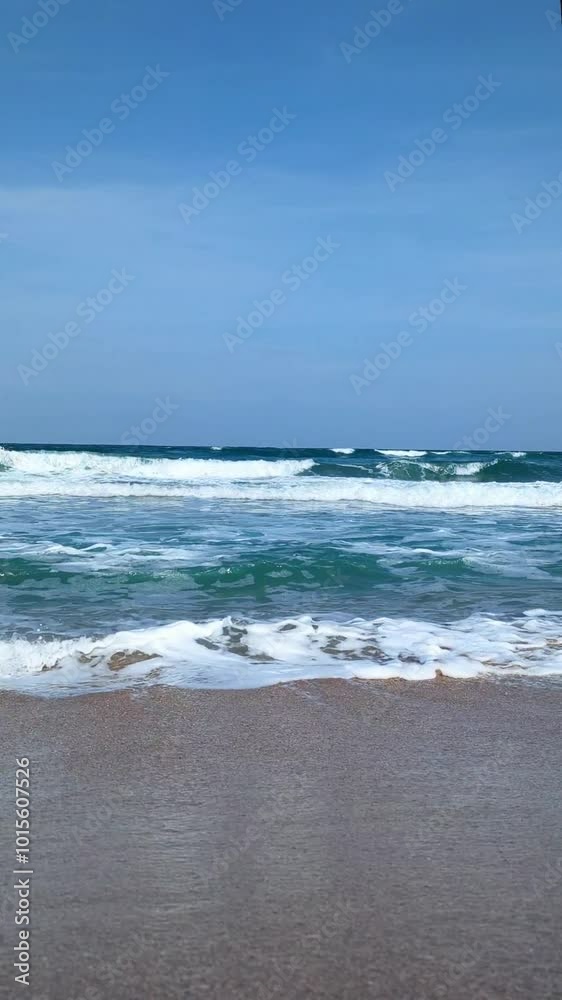 The sea and sandy beach. A storm is brewing over the water, with waves crashing and frothing as they spread across the shore. The sea and sandy beach. A storm is brewing over the water, with waves crashing and frothing as they spread across the shore.