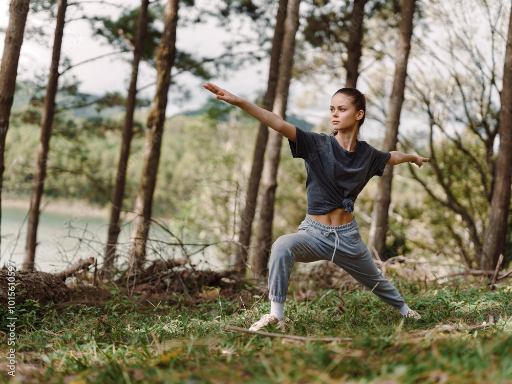 Focused young woman practicing yoga in serene forest setting, showcasing strength and balance Nature and wellness concept, promoting mindfulness and fitness Focused young woman practicing yoga in serene forest setting, showcasing strength and balance Nature and wellness concept, promoting mindfulness and fitness