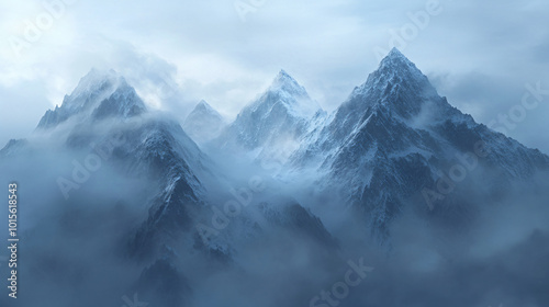 A misty mountain range in the early morning light, with clouds drifting between the peaks.