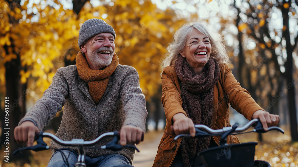 Obraz premium Happy Senior Couple Biking in Autumn Park