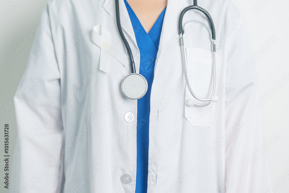 November Lung Cancer Awareness month and Stop Violence Against Women. Doctor with White ribbon in hospital. Healthcare and World Cancer day concept November Lung Cancer Awareness month and Stop Violence Against Women. Doctor with White ribbon in hospital. Healthcare and World Cancer day concept