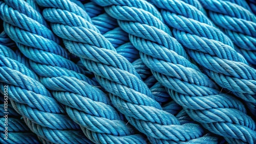 Close up shot of a thick, blue rope showing intricate details of woven strands and fabric texture, rope, blue, thick