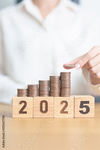 Happy New Year 2025 with Coins stack. Money, Budget, tax, investment, financial, savings and New Year Resolution concepts