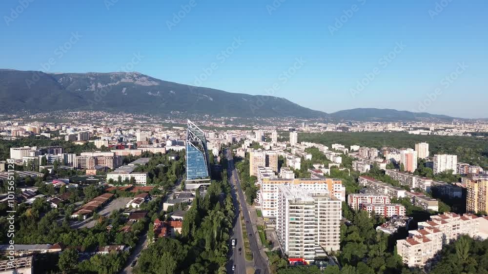 Aerial cityscape of Sofia, Bulgaria. Vitosha mountain in the background on a sunny day with a clear blue sky. Drone sho of an East European capital city with a mix of old and modern buildings Aerial cityscape of Sofia, Bulgaria. Vitosha mountain in the background on a sunny day with a clear blue sky. Drone sho of an East European capital city with a mix of old and modern buildings