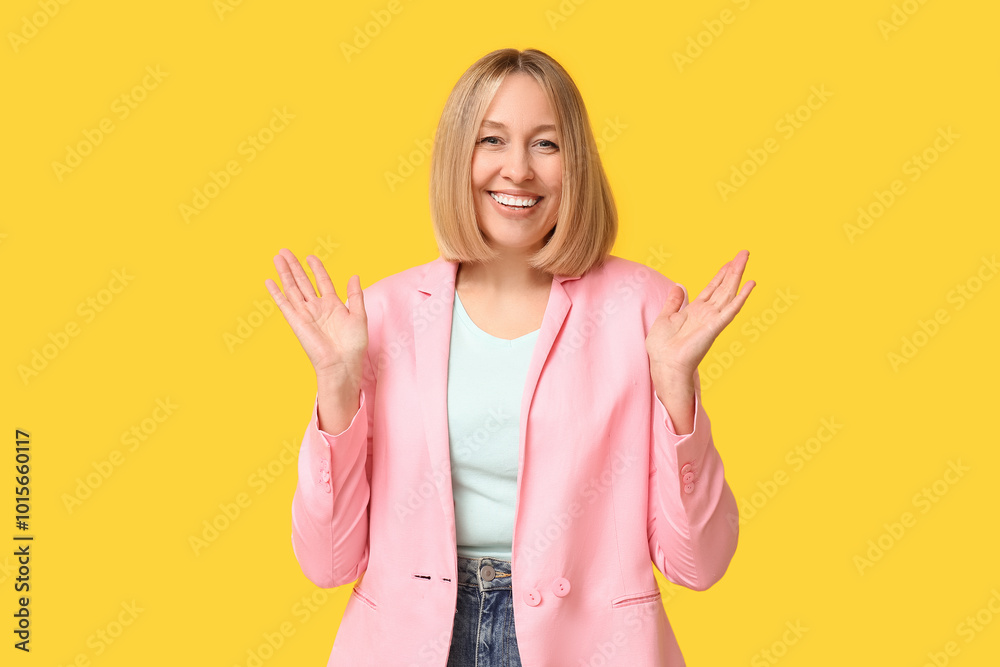 Happy young woman with bob hairstyle on yellow background