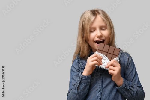 Cute little girl eating swe...