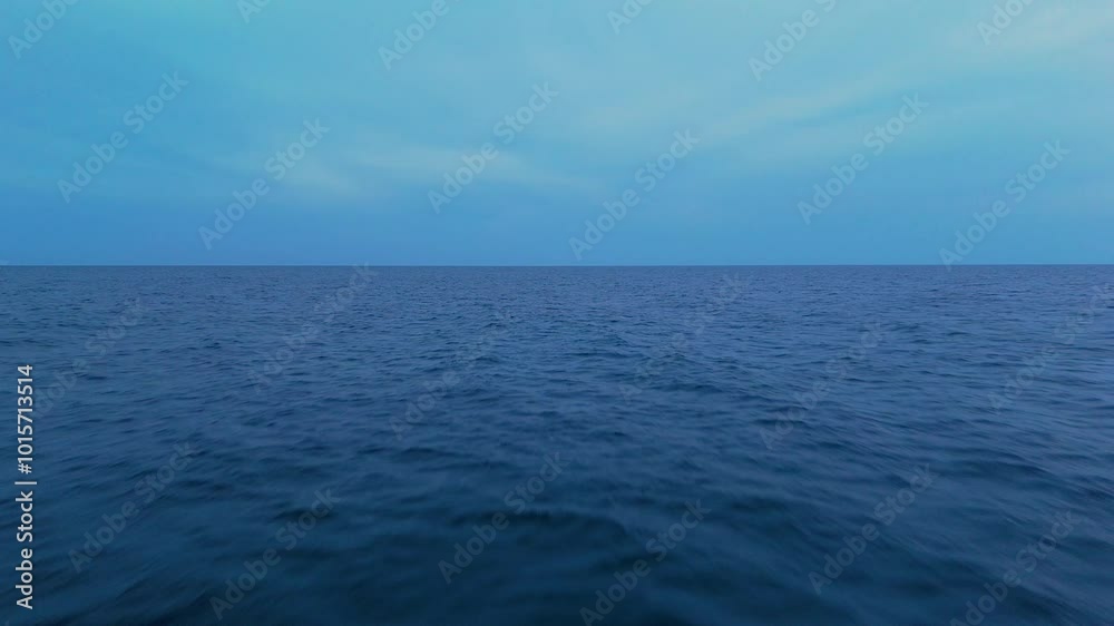 Calm ocean water under a bright sky with soft ripples and a vast open horizon Calm ocean water under a bright sky with soft ripples and a vast open horizon