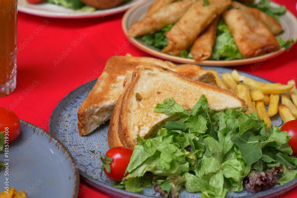 Enjoy a Delicious Meal featuring Toast, a Fresh Salad, and Crispy Spring Rolls on the Side