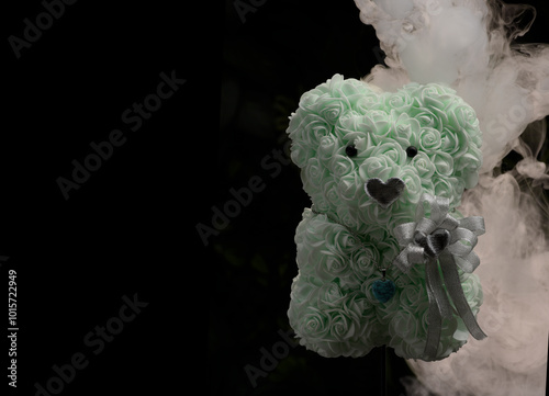 Small homemade teddy from rose shapes and decorated with love hearts with strange swirling fog and mist photo